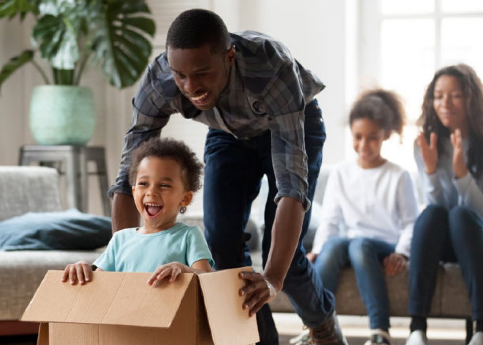 Dad and child playing with cardboard box