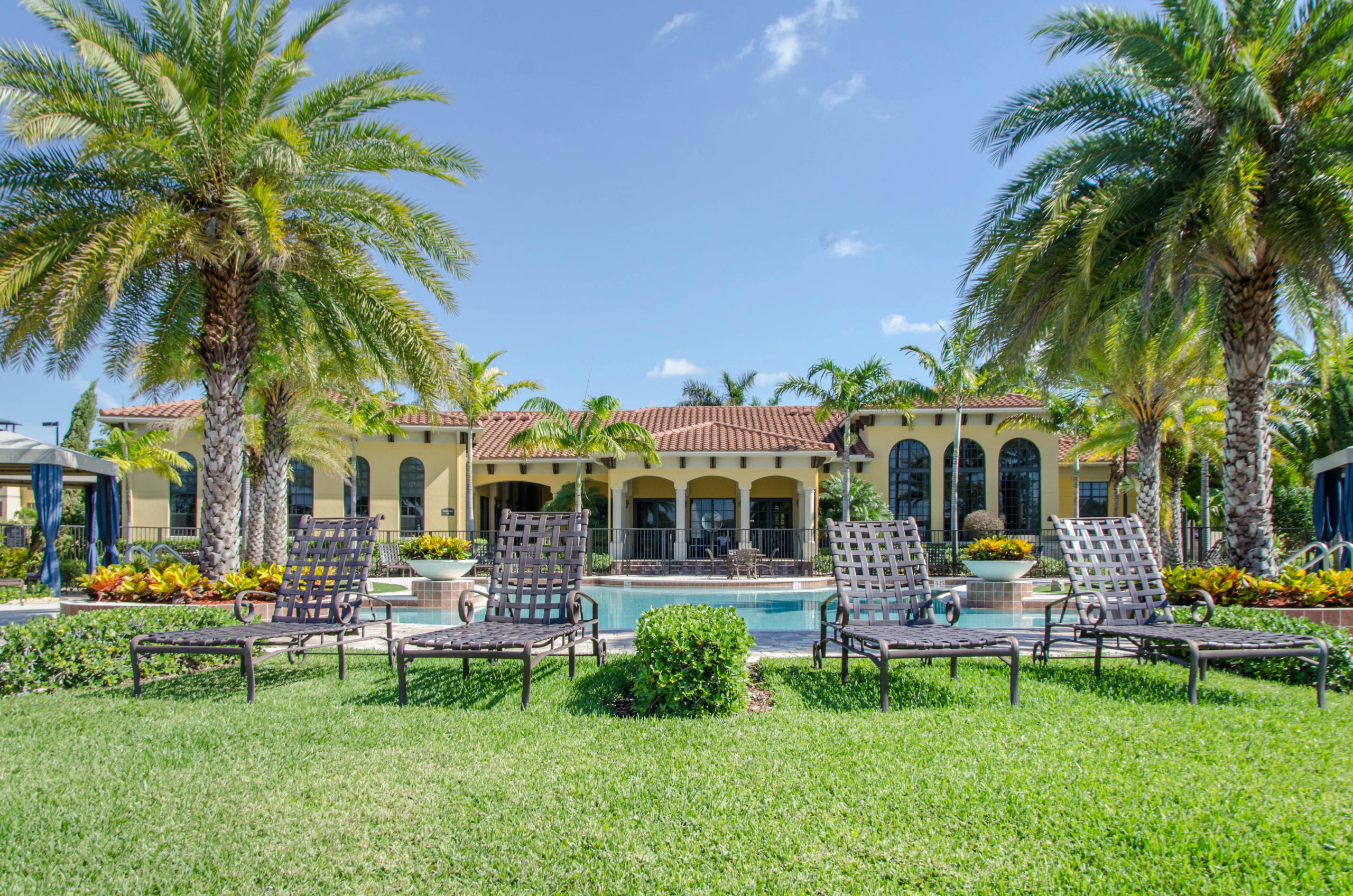 The outdoor pool and lounge chairs at The Point at Royal Palm Beach