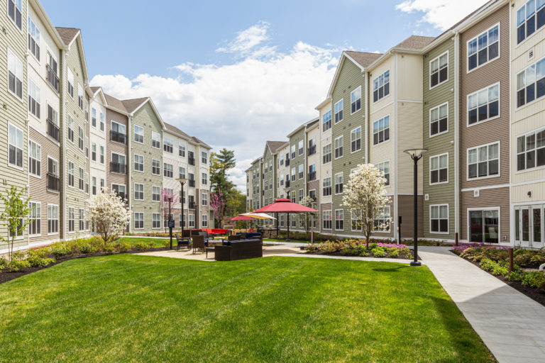 Outdoor seating area with umbrellas at The Point at Sharon