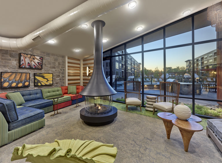 Community den featuring fireplace and comfortable seating at The Point at Downingtown