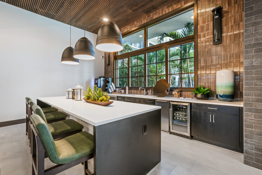 Community kitchen with bar seating at The Point at District Flats