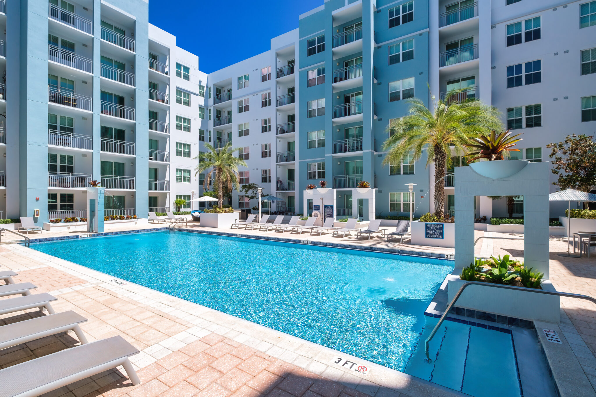 Outdoor pool with lounge seating at The Point at Coral Gables